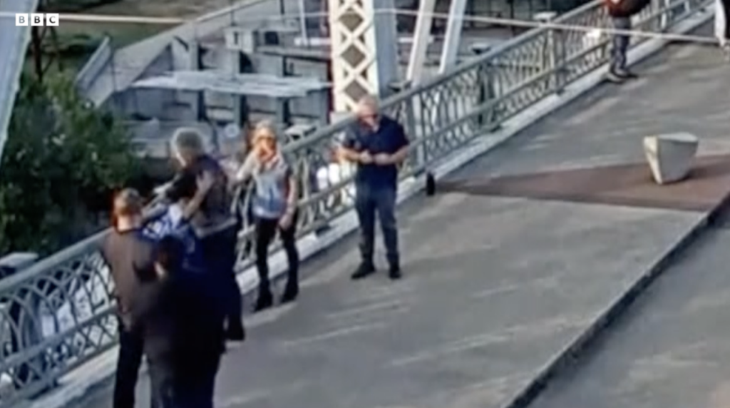 Jon Bon Jovi giving a woman a hug on the John Seigenthaler Pedestrian Bridge